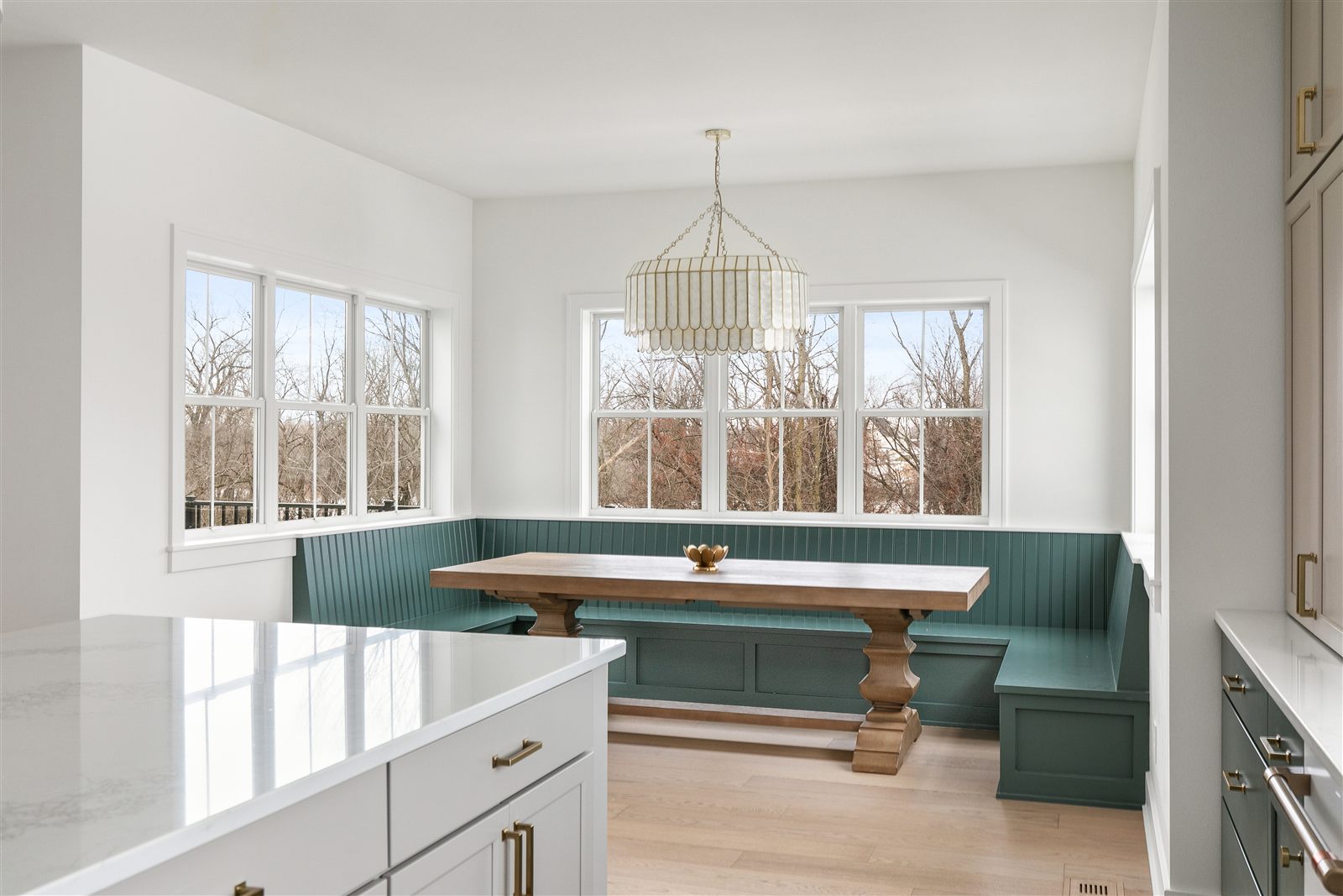 Custom breakfast nook with built-in green bench in a Sage Built home