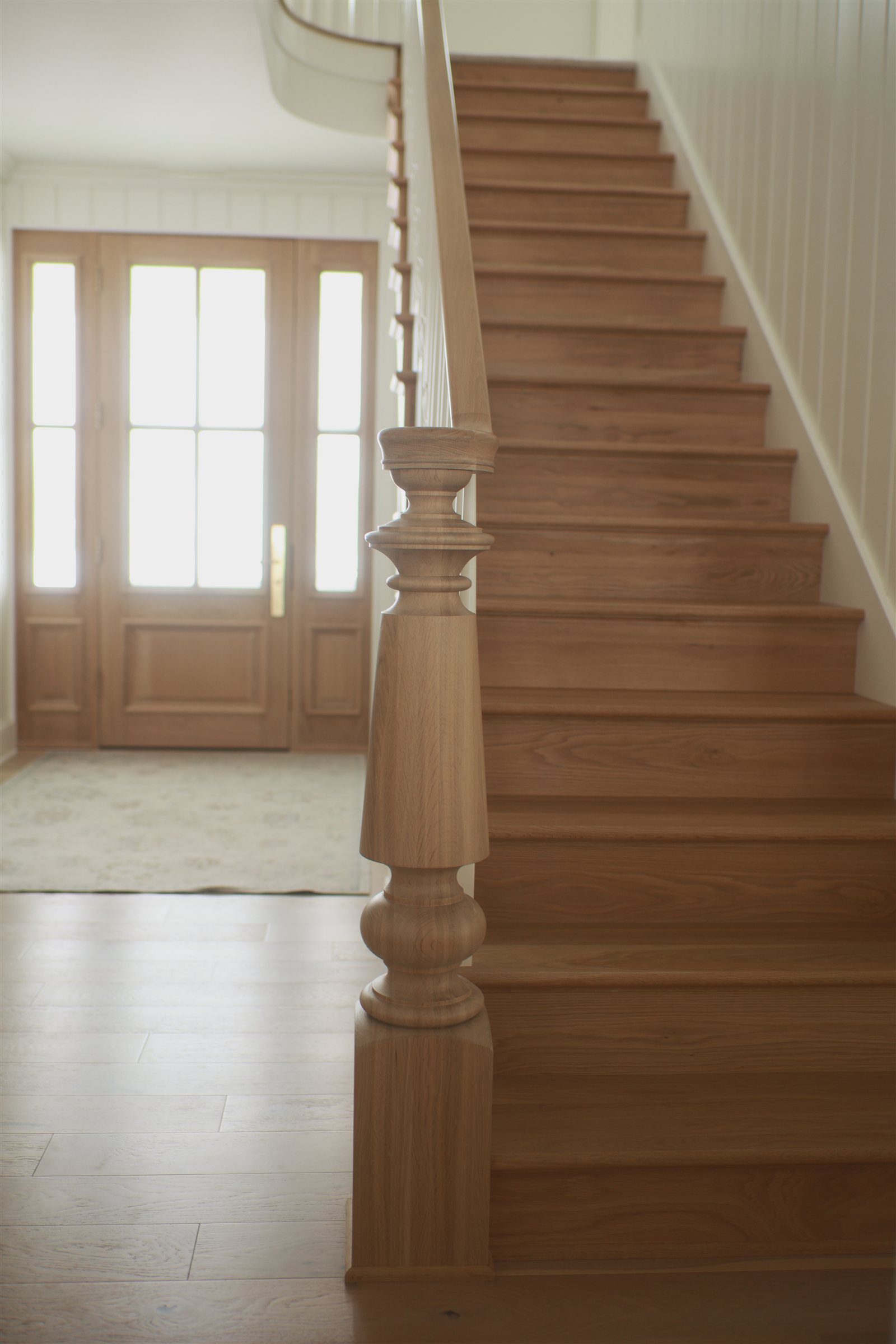 Custom white oak staircase in a Sage Built home